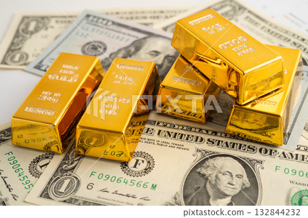 Gold bars with US dollar banknote money, finance trading investment business currency. Gold bars with US dollar banknote money, finance trading investment business currency. 132844232