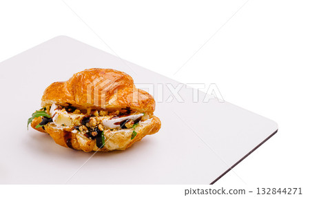 Delicious pastry filled with cheese and herbs on a white plate Delicious pastry filled with cheese and herbs on a white plate 132844271