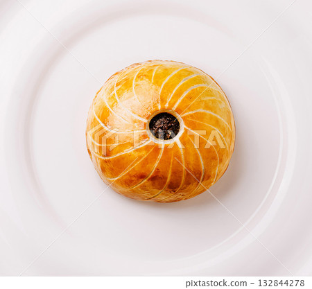 Unique pastry with spiral design served on a white plate Unique pastry with spiral design served on a white plate 132844278