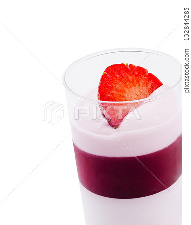 Strawberry dessert with creamy layers in a clear glass on a white background 132844285