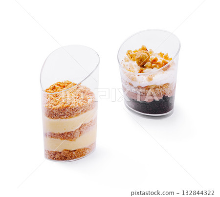 Desserts served in clear cups with layers of cream and toppings Desserts served in clear cups with layers of cream and toppings 132844322