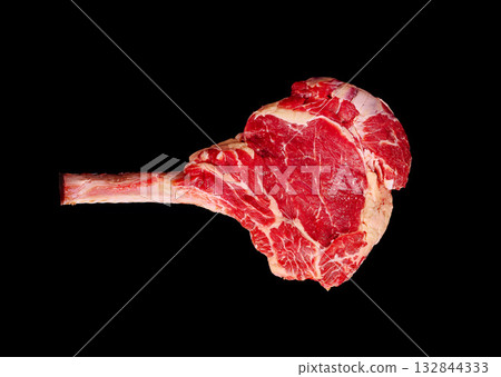 Tomahawk steak on a black background ready for grilling or cooking Tomahawk steak on a black background ready for grilling or cooking 132844333