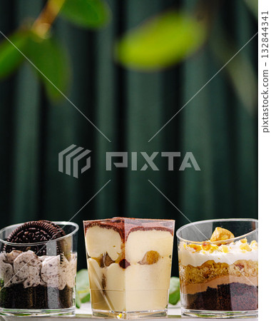 Delicious layered desserts in elegant glass cups on display 132844341