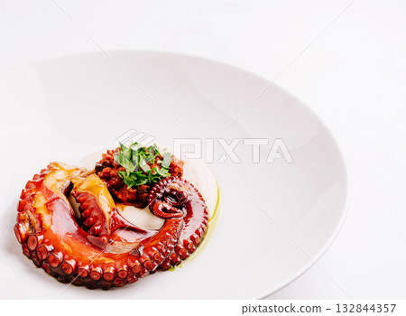 Grilled octopus served on plate with sauce and herbs Grilled octopus served on plate with sauce and herbs 132844357