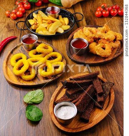 Enjoying a vibrant spread of savory snacks at a cozy table setting Enjoying a vibrant spread of savory snacks at a cozy table setting 132844368