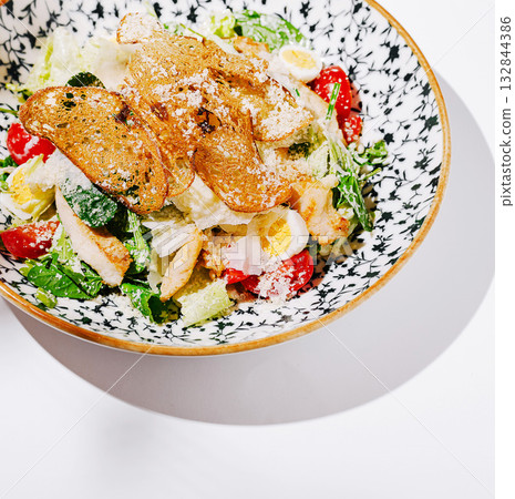 Fresh salad bowl with crispy toppings and vibrant ingredients 132844386