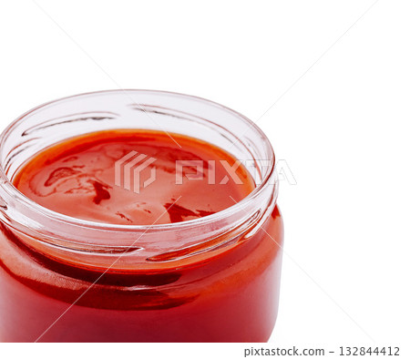 Rich tomato sauce in a clear glass jar on a white background Rich tomato sauce in a clear glass jar on a white background 132844412