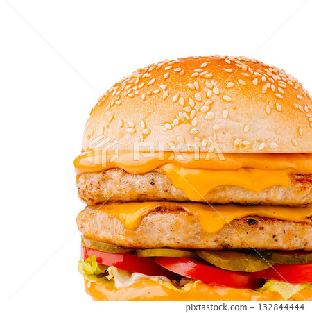 Delicious cheeseburger stacked with fresh veggies from a fast food restaurant Delicious cheeseburger stacked with fresh veggies from a fast food restaurant 132844444