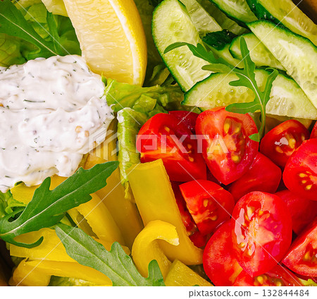 Fresh vegetable salad featuring cucumbers, bell peppers, and cherry tomatoes Fresh vegetable salad featuring cucumbers, bell peppers, and cherry tomatoes 132844484