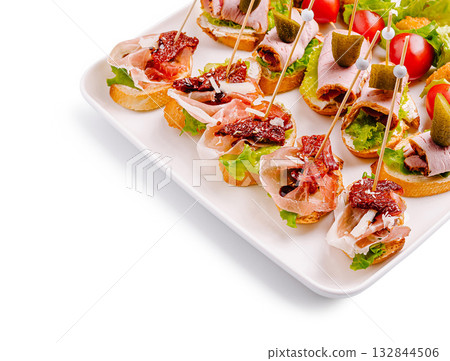 Delicious catering platter with assorted canapes at a festive gathering 132844506