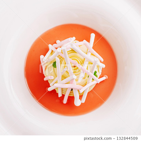 Delicate dessert creation on colorful jelly plate with candy accents Delicate dessert creation on colorful jelly plate with candy accents 132844509