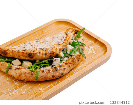 Delicious flatbread filled with fresh ingredients served on wooden tray 132844512