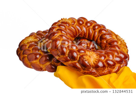 Freshly baked traditional bread rings on a bright yellow cloth 132844531