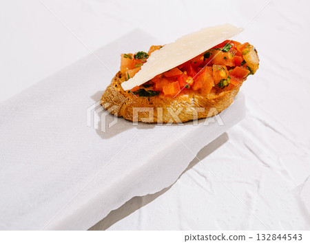 Fresh bruschetta with tomatoes and herbs on rustic bread slice 132844543