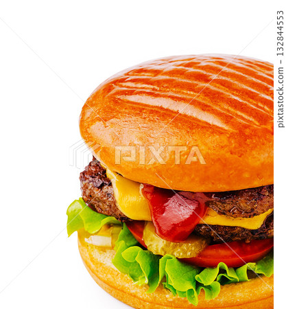 Juicy hamburger topped with cheese, lettuce, and condiments on a warm bun Juicy hamburger topped with cheese, lettuce, and condiments on a warm bun 132844553