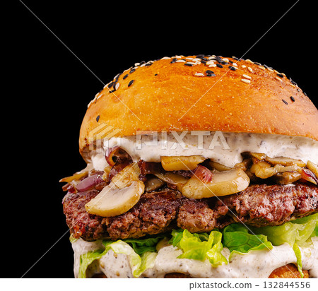 Juicy mushroom and beef burger served on sesame seed bun with fresh toppings Juicy mushroom and beef burger served on sesame seed bun with fresh toppings 132844556
