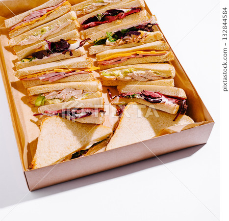 Various sandwiches arranged in a takeout box for a food display event Various sandwiches arranged in a takeout box for a food display event 132844584