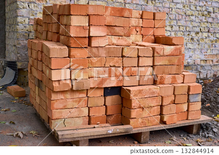 Construction. Stacked bricks on a wooden pallet, ready for installation. 132844914