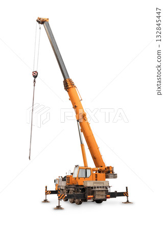 A large, yellow and orange mobile telescopic crane with its boom extended high and stabilizers deployed, isolated on white. 132845447