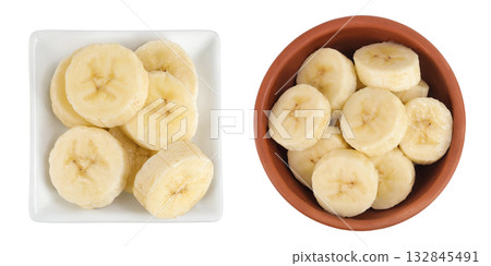 peeled banana pieces in ceramic bowl isolated on white background. Top view. Flat lay. 132845491