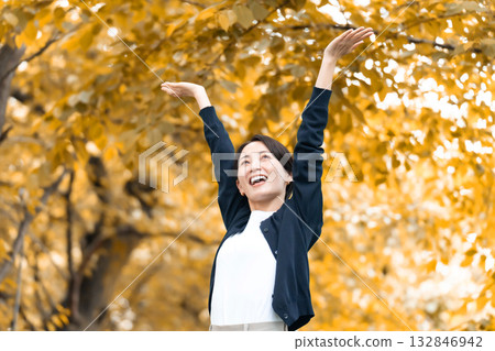 Woman walking in the autumn park Woman walking in the autumn park 132846942