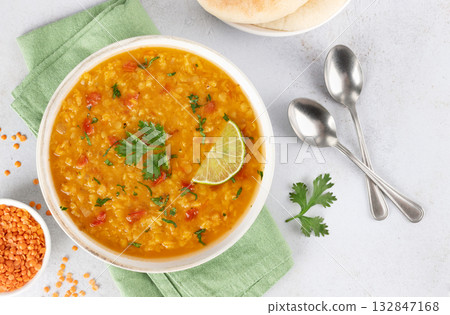 Traditional Indian dal soup with red lentils, spices fresh cilantro on white background. Indian food Traditional Indian dal soup with red lentils, spices fresh cilantro on white background. Indian food 132847168