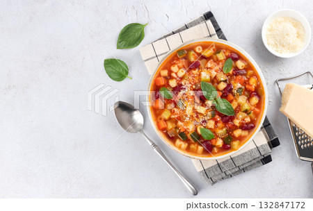 Italian vegetarian soup with vegetables and pasta on white background. Minestrone soup. Italian food Italian vegetarian soup with vegetables and pasta on white background. Minestrone soup. Italian food 132847172