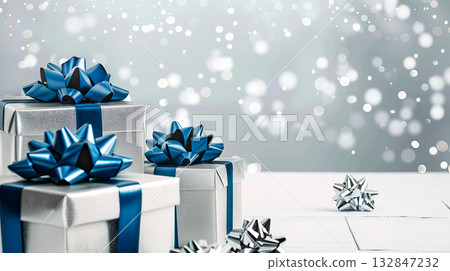 Silver gift boxes, blue bow, confetti on gray background. Copy space. Christmas, birthday, sale 132847232