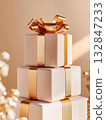 White gift box with a golden bow on a beige background. Holiday concept, birthday, sale, marketing.  132847233