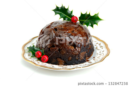 Christmas pudding with holly berries on a white background. Traditional festive food. Copy space. Christmas pudding with holly berries on a white background. Traditional festive food. Copy space. 132847238