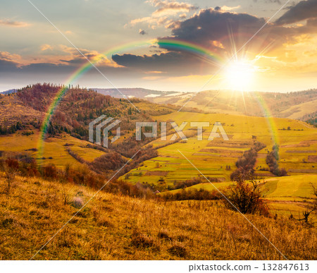 countryside mountain landscape in autumn at sunset. alps in evening light. beautiful place under rainbow. scenery with forest on rolling hills. beauty in nature and rural sustainability concept countryside mountain landscape in autumn at sunset. alps in evening light. beautiful place under rainbow. scenery with forest on rolling hills. beauty in nature and rural sustainability concept 132847613