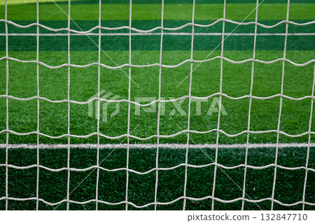 Close view of a goal net on a football field 132847710
