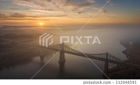 Foggy Sunrise View with Bridge Over River in Golden Light 132848591