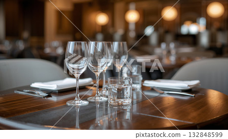 Elegant restaurant table setting with wine glasses and water glasses 132848599