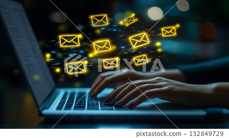 Hands typing on a laptop with email icons flying around 132849729