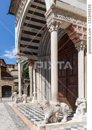 Marble lions support sculpted columns beneath Renaissance arch of white and pink stone in Bergamo Marble lions support sculpted columns beneath Renaissance arch of white and pink stone in Bergamo 132849836