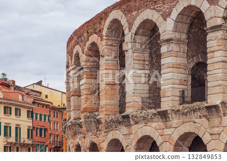 Roman arches of Verona Arena stand near bright facades of Piazza Bra blending old and modern charm Roman arches of Verona Arena stand near bright facades of Piazza Bra blending old and modern charm 132849853