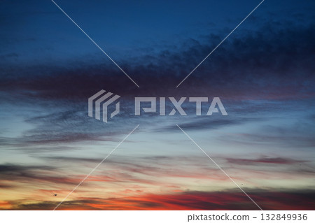 Evening sky with soft clouds and warm gradient tones during sunset creating abstract pattern 132849936