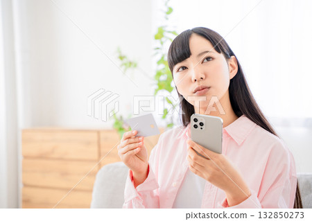 Young woman shopping online on her smartphone 132850273
