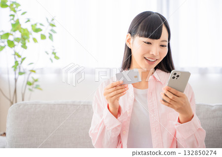 Young woman shopping online on her smartphone 132850274