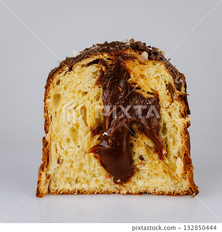 Sliced Christmas panettone with creamy chocolate filling, isolated on white background Sliced Christmas panettone with creamy chocolate filling, isolated on white background 132850444