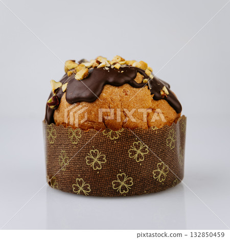 Christmas panettone with chocolate nut glaze isolated on white, festive holiday dessert 132850459