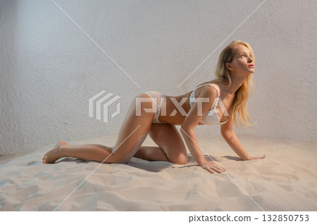 Beauty woman poses topless with angel wings in studio setting Beauty woman poses topless with angel wings in studio setting 132850753