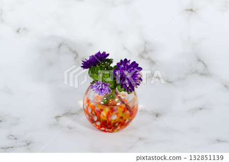 A chrysanthemum in a warm-colored glass vase (middle position in horizontal composition) A chrysanthemum in a warm-colored glass vase (middle position in horizontal composition) 132851139