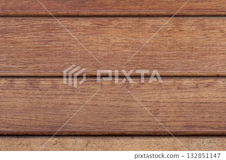 Warm brown wooden planks with subtle grain and texture 132851147
