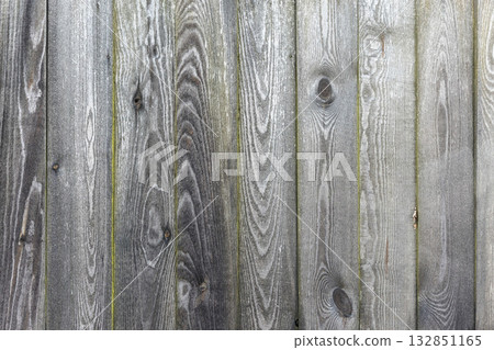 Close-up of weathered wooden fence planks with grain patterns Close-up of weathered wooden fence planks with grain patterns 132851165