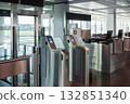 Automated airport gate at modern airport for scanning boarding pass. Concept of digitalization, self-check-in and independent travel. 132851340