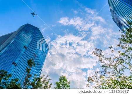 Tokyo cityscape in Japan. View of Takanawa Gateway City in front of Takanawa Gateway Station. Aircraft in the sky (F series) 132851687