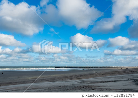calm shoreline with distant dock, tranquil seaside landscape featuring faraway jetty and soft clouds calm shoreline with distant dock, tranquil seaside landscape featuring faraway jetty and soft clouds 132851794