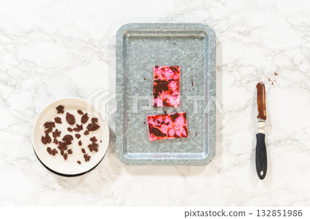 Flat lay. Making chocolate leaves from melted chocolate to decorate the pumpkin bundt cake. 132851986